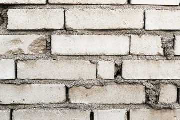 An old wall of white bricks close up