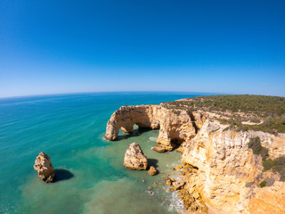 Aerial view on Praia de Marinha in Algarve, Portugal. Rock formations and cliffs on coast of Atlantic Ocean 