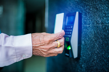 Door access control. Staff holding a key card to lock and unlock door at home or condominium.