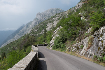 Road P1 from Kotor to Cetinje in Montenegro, with mountains in the background.