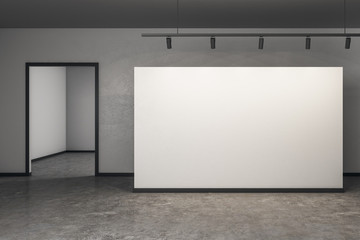 Bright concrete gallery with poster