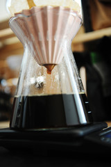 Alternative filter black coffee pour over brewing with pink origami dripper. Specialty concept. Dripping close up