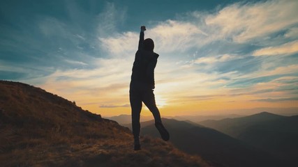 The man running on the mountain against the beautiful sunrise. slow motion - Powered by Adobe
