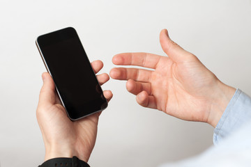 Hand holding and Touch on Black Smartphone with blank screen on white background