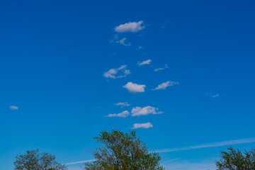 Clouds against a blue sky. White clouds against a blue sky. White clouds blue sky on a spring day.