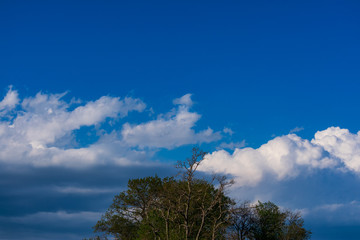 Clouds against a blue sky. White clouds against a blue sky. White clouds blue sky on a spring day.