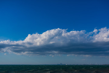 Clouds over water. Clouds against a blue sky. Blue sky with clouds on a sunny day.