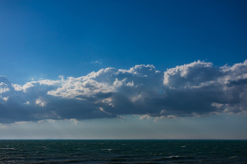 Obraz premium Clouds over water. Clouds against a blue sky. Blue sky with clouds on a sunny day.