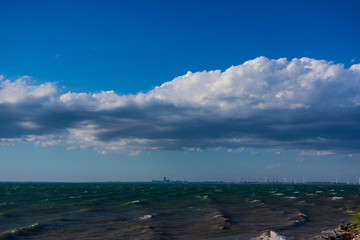 Clouds over water. Clouds against a blue sky. Blue sky with clouds on a sunny day.
