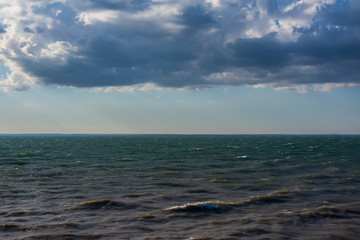 Obraz premium Clouds over water. Clouds against a blue sky. Blue sky with clouds on a sunny day.