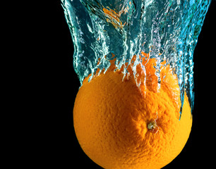 A wonderful orange in a spray of water. Macro