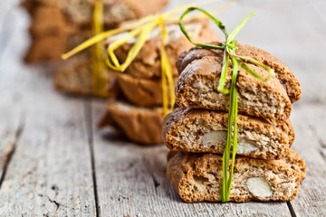 Fresh homemade Italian cookies cantuccini with almond seeds on ructic wooden table background.