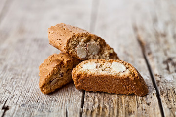 Homemade Italian cookies cantuccini heap with almond seeds on ructic wooden table