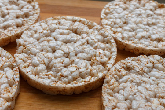 Round rice cakes on wooden table, side view. Rice cakes on the wooden tray background.