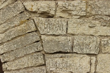 Obraz premium Masonry concept. Closeup stone wall of ancient fortress. Can be used as a background and space for text. Front view.