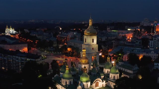 Aerial view of the St. Sophia Cathedral, illuminated at night, the monument to Bogdan Khmelnitsky and the center of Kiev
