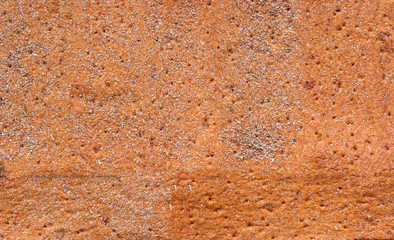 small loafs of bread on a wooden background.