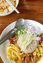 Fototapeta Thai food - Kao Cluk Ka Pi (Mixed Cooked Rice with Shrimp Paste Sauce) on white round dish obraz