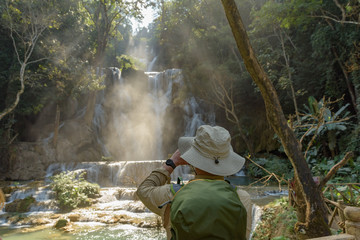 An unidentified man at the beautiful Kuang Si Waterfall near Luang prabang in Laos.