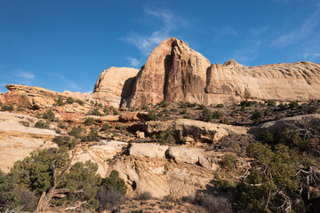 Fototapeta na wymiar Monolithic rock formations are found throughout Capital Reef National Park, Utah. Navajo Dome can be seen on the trail to Hickman Arch.