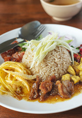 Thai food - Kao Cluk Ka Pi (Mixed Cooked Rice with Shrimp Paste Sauce) on white round dish