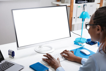 Businesswoman Working On Computer With Blank White Screen