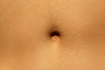 Closeup - navel of the stomach - belly button. Slim nude young woman belly. - obrazy, fototapety, plakaty