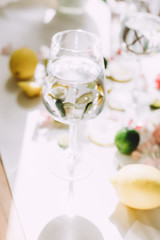 Slices of lemon and lime lying on the table with a sunlight through the glass