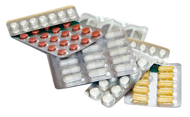 Set of multicolor pills in white blister packs