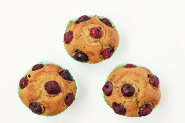Cupcakes with a cherry on a white background, top view