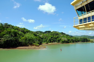 Green landscape of the Panama Canal, view from transiting container ship.
