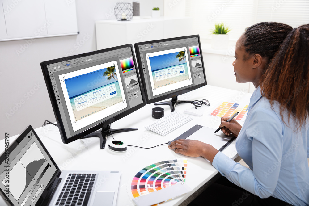 Poster designer editing photos on computer