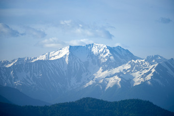 Fototapeta na wymiar Snow-capped peaks of the North Caucasus at sunrise.