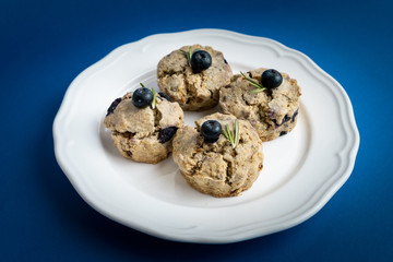 Fresh Baked Raspberry and Blueberry oatmeal wheat Scones set on Blue Background.