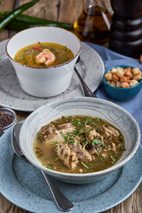 A set of healthy food in plates. Set of food in a cafe - soup and salad on a served table. On a wooden background. Copy space.