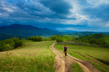 Fototapeta na wymiar Girl travelling through beautiful epic mountain landscape