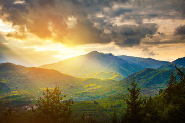 Sun rays beams over rural mountain resort epic landscape