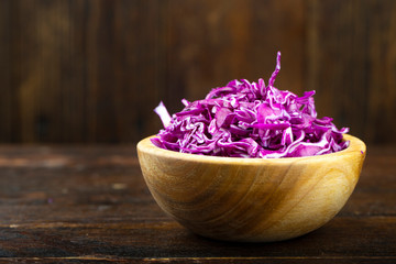Red cabbage in a wooden plate finely chopped.