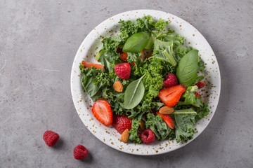 Vitamin salad with kale salad, basil, strawberry, raspberry and nuts