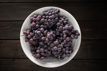 Top view of fresh red grapes in white bowl