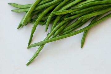 Bunch of green beans lying on a light table