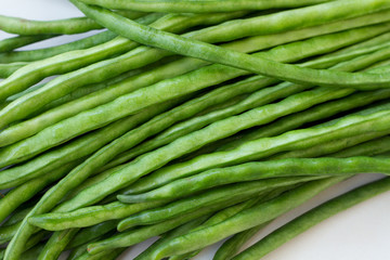 Green beans lying on the table background