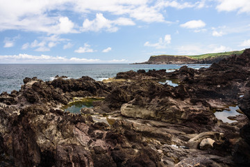 seascape in terceria, view of the rocky seaside in terceira with cliff in the background. seascape in azores, portugal.