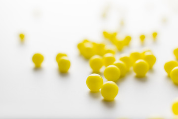 yellow pills of vitamins on a white background for the medical treatment of diseases in the hospital
