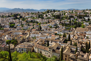 Fototapeta na wymiar View of Albaicin with Churches and tile rooftops from Alcazaba fortress in Granada Spain