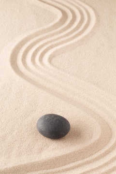 meditation stone in Japanese zen garden. Concept for focus and  concentration to reach spiritual balance, purity and harmony of mind and soul. Spa wellness or mindfulness background with copy space. .