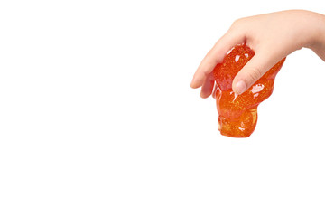 kid playing orange slime with hand, transparent toy