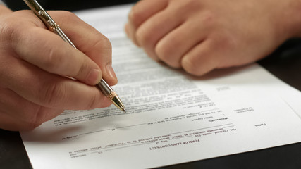 Male hand signing contract closeup, businessman making deal, agreement approval