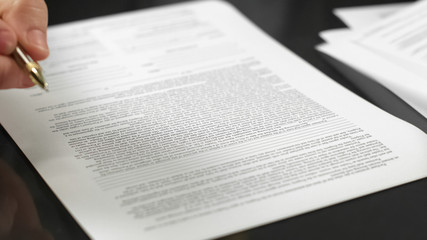 Businessman holding pen signing agreement, making deal, real estate rent, credit