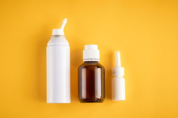 Nasal spray bottle composition, white template bottle on yellow background